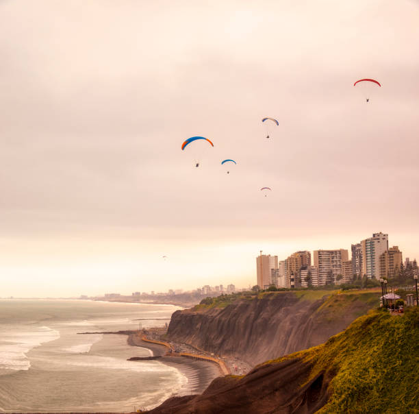 Paragliders Over The Coast In Lima, Peru Paragliders Over The Coast In Lima, Peru lima peru stock pictures, royalty-free photos & images