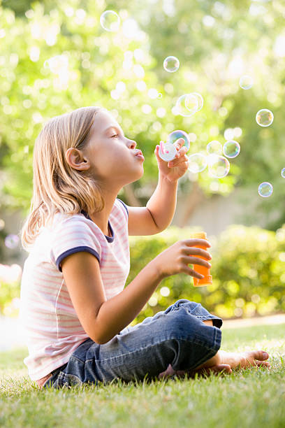 istock Young girl blowing bubbles outdoors 104440951