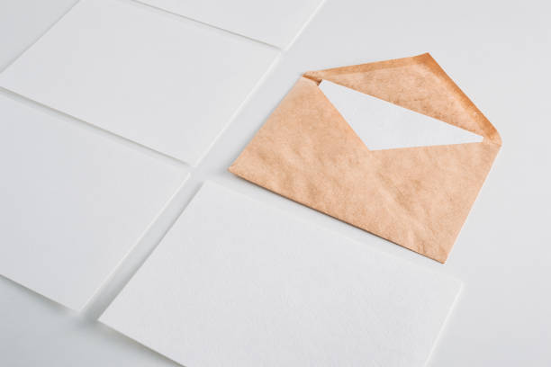 istock White paper empty sheets cards and kraft envelope on a white background. Mockup for design 1044417892