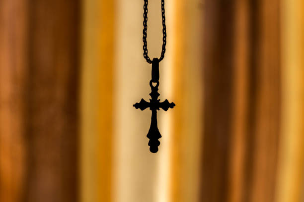 istock a cross on a chain on an orange background 1044423146