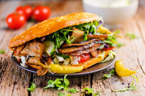 istock Delicious kebab sandwich on wooden background 1044429538