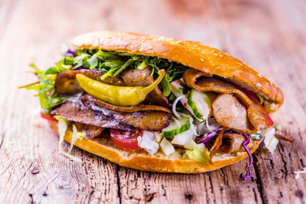 istock Delicious kebab sandwich on wooden background 1044433352