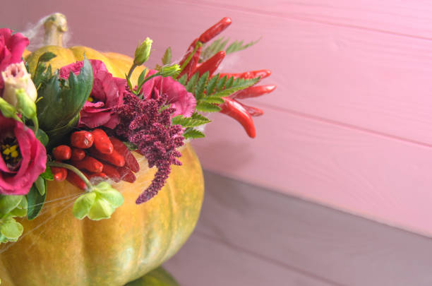istock Halloween pumpkin with flowers and leaves on mirror table. 1044433554
