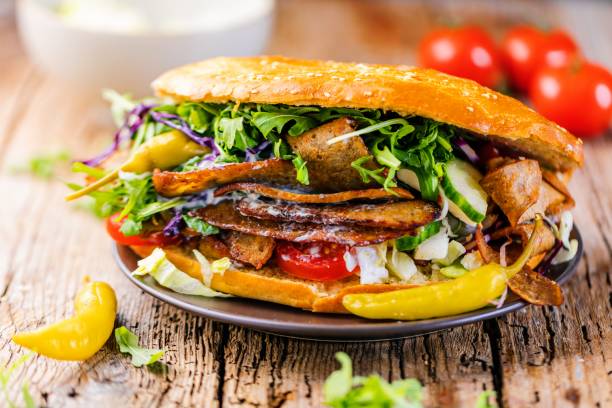 istock Delicious kebab sandwich on wooden background 1044435778