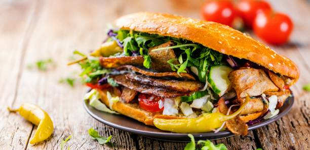 istock Delicious kebab sandwich on wooden background 1044435984