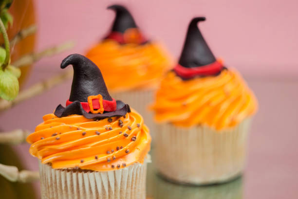 istock Group of helloween cupcakes on pink background. Helloween treat. 1044437044