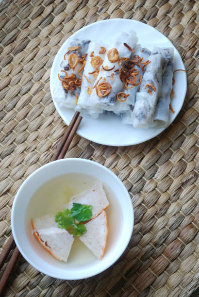istock Banh cuon-vietnamese steamed rice rolls with minced meat inside accompanied by bowl of fish sauce. 1044437370
