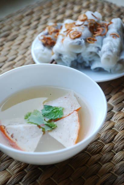 istock Banh cuon-vietnamese steamed rice rolls with minced meat inside accompanied by bowl of fish sauce. 1044443686