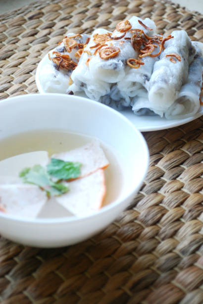 istock Banh cuon-vietnamese steamed rice rolls with minced meat inside accompanied by bowl of fish sauce. 1044443798