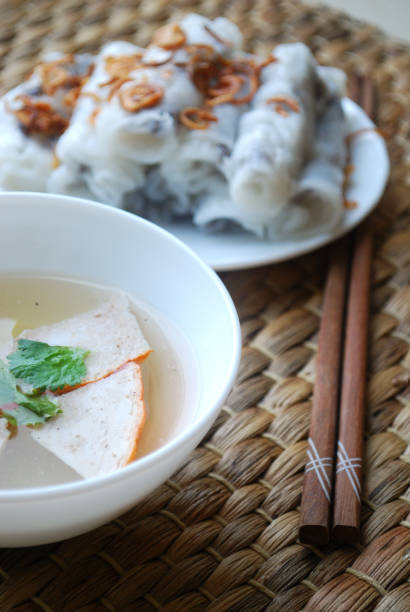 istock Banh cuon-vietnamese steamed rice rolls with minced meat inside accompanied by bowl of fish sauce. 1044443854