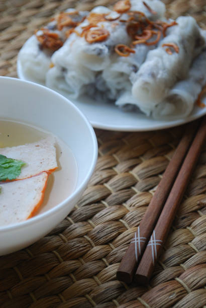 istock Banh cuon-vietnamese steamed rice rolls with minced meat inside accompanied by bowl of fish sauce. 1044443904