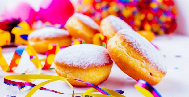 istock Carnival powdered sugar donuts with paper streamers 1044443926