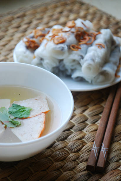 istock Banh cuon-vietnamese steamed rice rolls with minced meat inside accompanied by bowl of fish sauce. 1044443998
