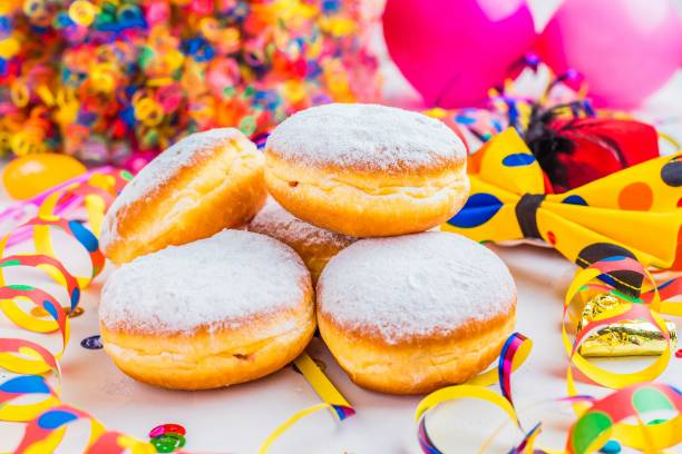 istock Carnival powdered sugar donuts with paper streamers 1044444218