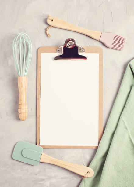 istock Paper clipboard with empty space and kitchen utensils top view 1044447278