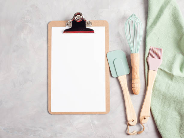 istock Paper clipboard with empty space and kitchen utensils top view 1044447342