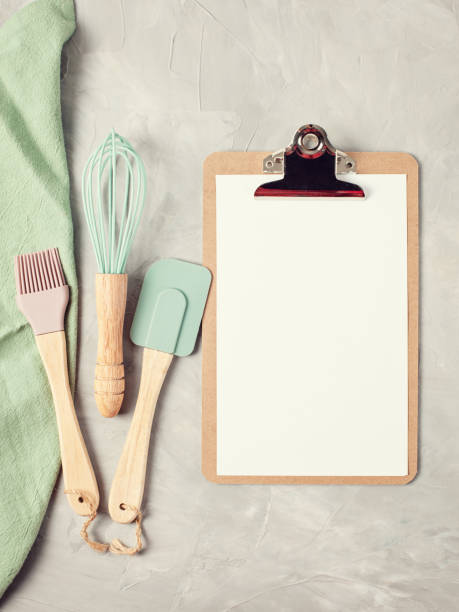 istock Paper clipboard with empty space and kitchen utensils top view 1044447348