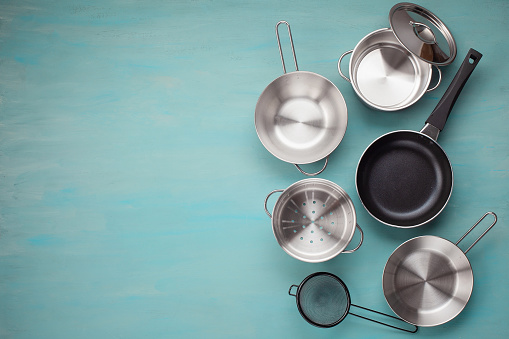 Set of kitchen metallic pans. Mockup, kitchen utensils, recipe book, cooking classes concept