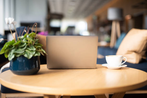istock Laptop, cup of coffee and flower on table. 1044447874