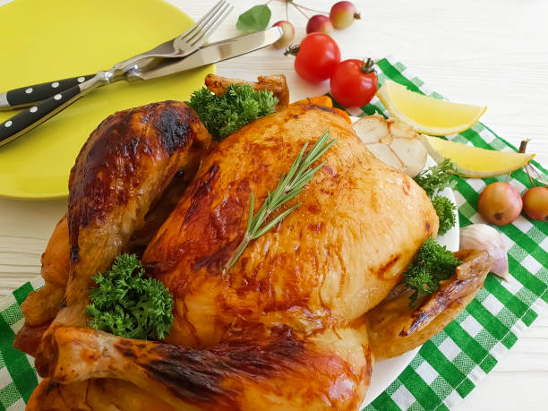 istock fried chicken whole, garlic, lemon tomatoes on a wooden background 1044448528
