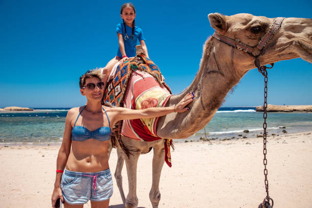 istock Mother and Daughter Enjoying Riding a Camel in Egyot 1044448606