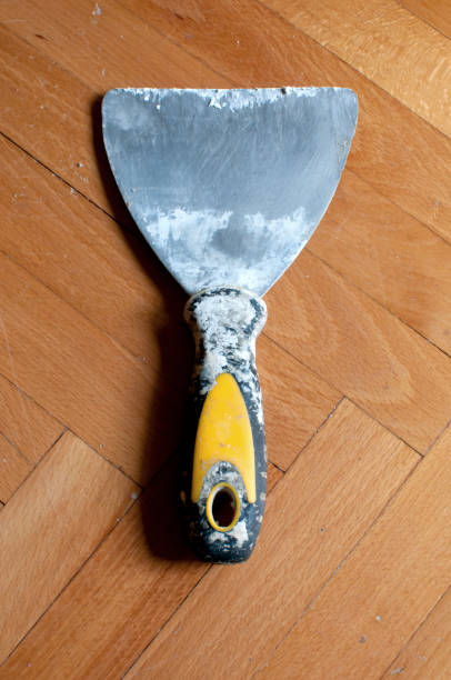 istock old dirty scraper on wooden floor close up 1044448812