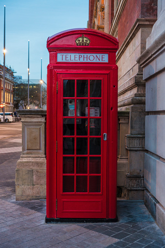 Red telephone box on a street in London, England, United Kingdom