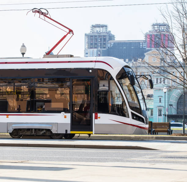 istock Modern tram moves at high speed through city streets. 1044453110