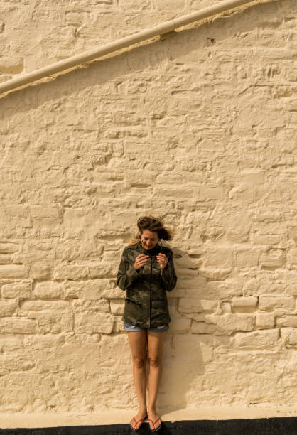 istock Woman looking down taking off glasses with strong wind 1044453480