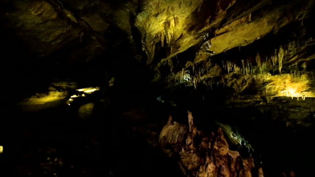 Inside dark cave with yellow light in Caucasian mountains in Kutaisi, Georgia