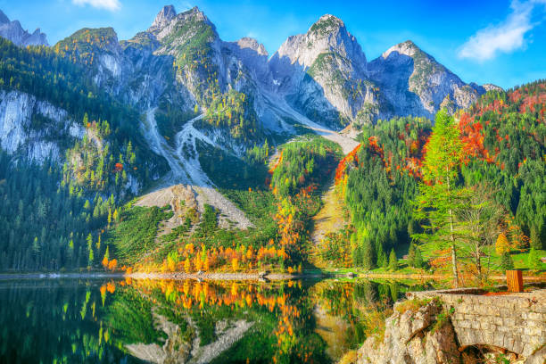 istock colorful autumn scenery with Dachstein mountain summit by Gosausee mountain lake 1044457458