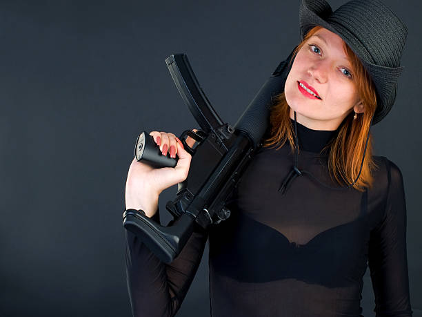 istock young woman holding the gun 104445957