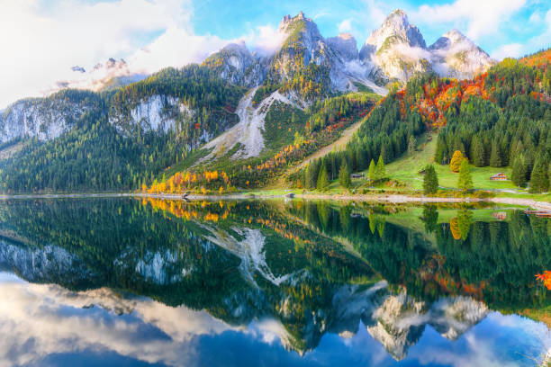 istock colorful autumn scenery with Dachstein mountain summit reflecting in crystal clear Gosausee mountain lake 1044460324