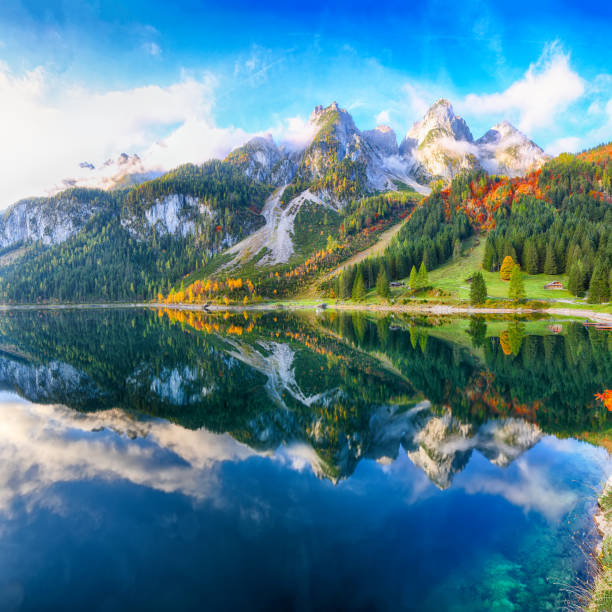 istock colorful autumn scenery with Dachstein mountain summit reflecting in crystal clear Gosausee mountain lake 1044460662