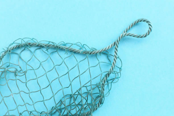istock Fishing net with space for your text. Blue background for a fishery theme. 1044460822