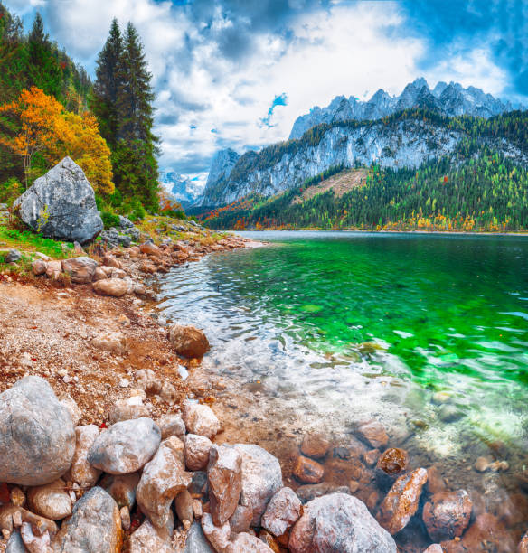 istock colorful autumn scenery with Dachstein mountain summit reflecting in crystal clear Gosausee mountain lake 1044460892