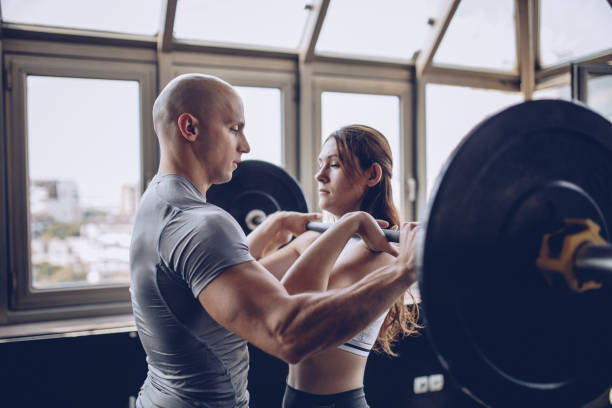 istock Showing woman weightlifting exercise 1044460898