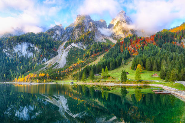 istock colorful autumn scenery with Dachstein mountain summit reflecting in crystal clear Gosausee mountain lake 1044460954