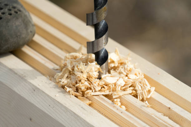 istock The man drilling the wood. Place for your text. 1044460980