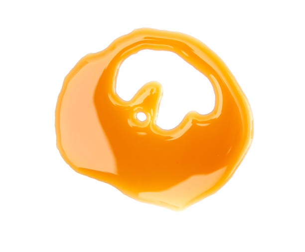 istock A Twirl of Maple Syrup Spilled on a White Background 1044464398
