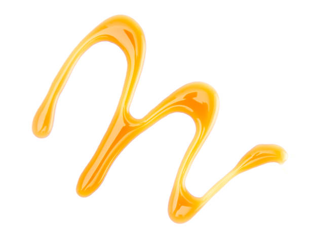 istock A Twirl of Maple Syrup Spilled on a White Background 1044464400