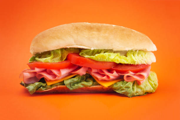 istock A Single Ham Sandwich with Lettuce Cheese and Tomatoes on a White Bun 1044464404