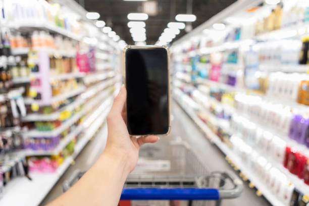 istock Woman uses mobile app while shopping 1044467058