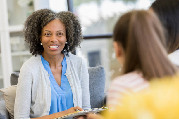 istock Cheerful high school guidance counselor talking with students 1044468800