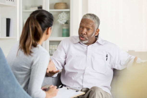istock Senior man talks with female counselor 1044469196