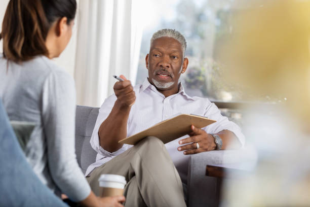 istock Experienced therapist talks with female patient 1044469222