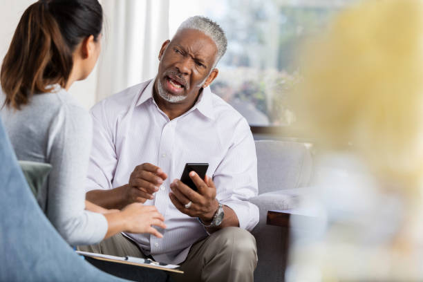 istock Upset man talks with female therapist 1044469234