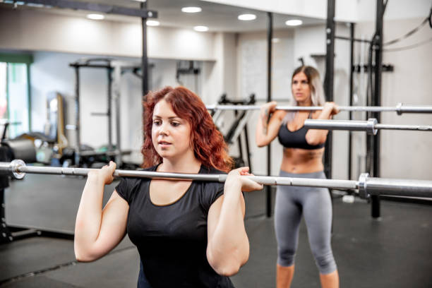 istock Young Women Weightlifting on Cross Training in Gym 1044469410