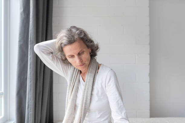 istock Middle aged woman rubbing neck 1044472256