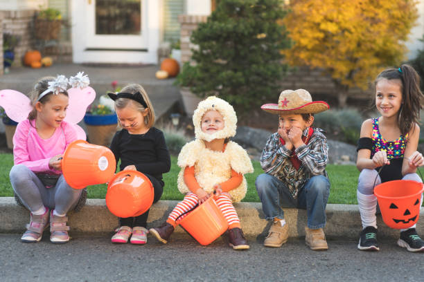 istock Trick or treaters sitting on a curb 1044472262